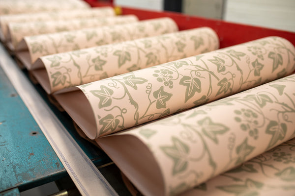 A stack of freshly painted Farrow & Ball wallpaper sheets in the pattern "Ivy"