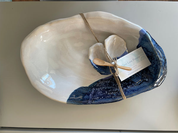 Large blue oyster platter with small oyster condiment dish